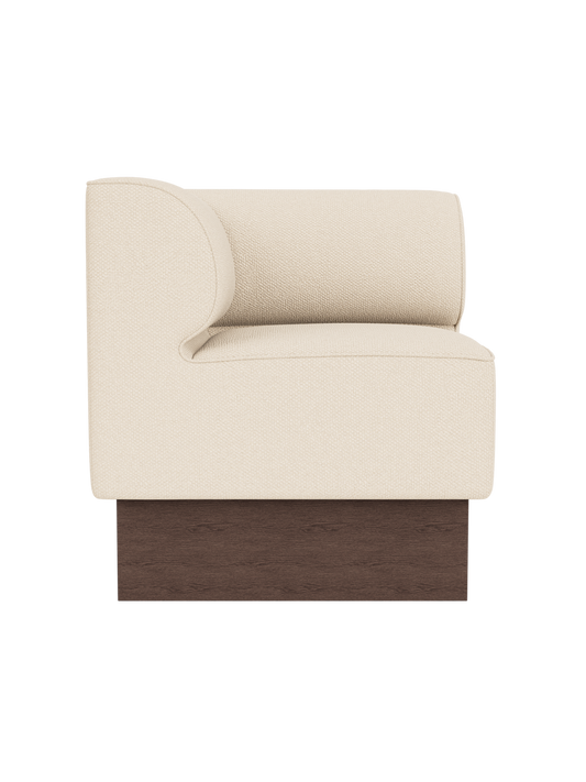 Eave Dining Sofa, Plateau in Logan Jasmine upholstery with a dark stained oak base, viewed from the side.