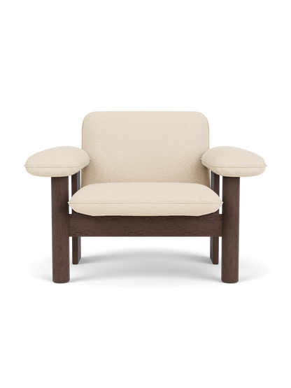 Front view of the Brasilia Lounge Chair, Low Back, with a dark stained oak frame and light Logan Jasmine textile upholstery.