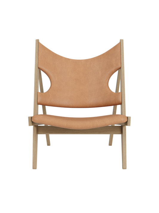 Knitting Lounge Chair in natural oak and Dunes Camel leather, featuring its signature winged back and elbow cut-outs.