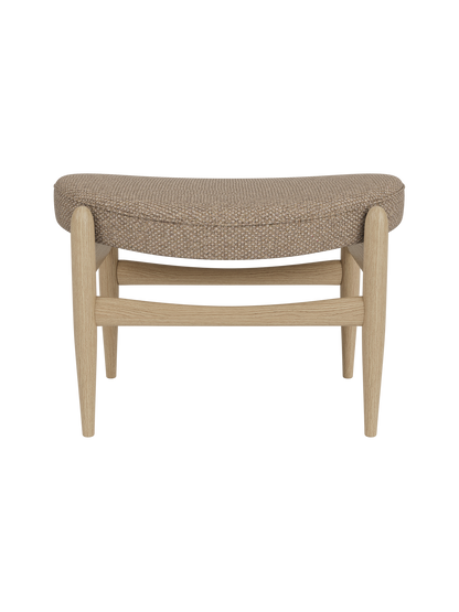 Elizabeth Ottoman in Logan Flint fabric and natural oak, featuring a curved upholstered seat and tapered wooden legs.