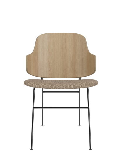 The Penguin Dining Chair featuring a sculptural natural oak back and Logan Flint upholstered seat on black steel legs.