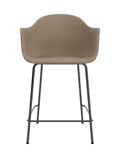 Harbour Counter Chair upholstered in textured Logan Flint fabric with slim black steel legs and integrated footrest.