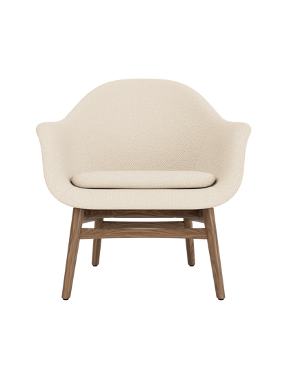 Harbour Lounge Chair in Logan Jasmine fabric with a solid walnut base, featuring a sculptural, curved shell.