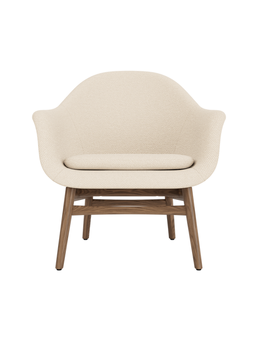Harbour Lounge Chair in Logan Jasmine fabric with a solid walnut base, featuring a sculptural, curved shell.