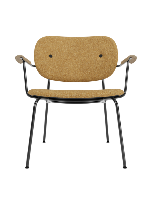 Co Lounge Chair fully upholstered in Moss 022 ochre fabric with natural oak armrests and a black steel frame.