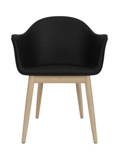 Harbour Dining Chair with a curved black Sierra 1001 upholstered shell and tapered natural oak wooden legs.