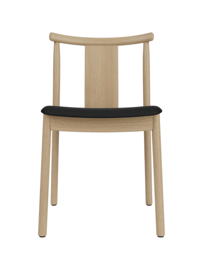 Merkur Dining Chair in natural oak with a black Sierra leather seat, featuring a curved backrest and solid wood frame.