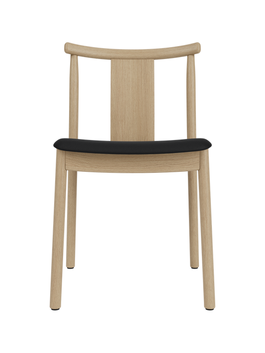 Merkur Dining Chair in natural oak with a black Sierra leather seat, featuring a curved backrest and solid wood frame.