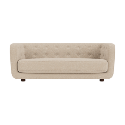 Vilhelm Sofa in cream Sahco Zero bouclé featuring a button-detailed back and rounded arms with dark-stained oak legs.
