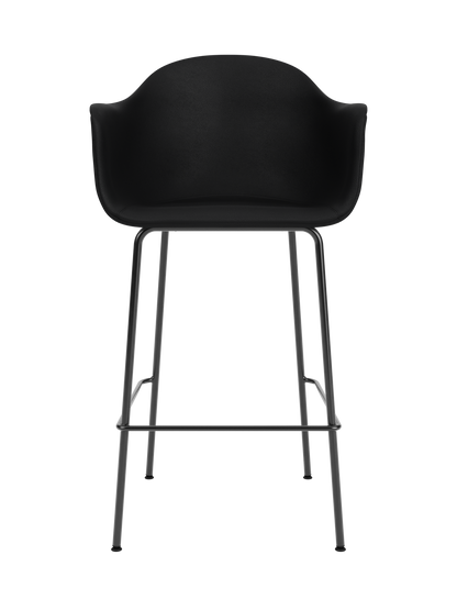 Black upholstered Harbour Bar Chair with a curved shell and slender black powder-coated steel legs and footrest.