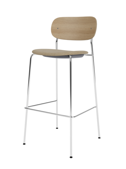 Co Bar Chair, Seat Upholstered featuring a slender chrome frame, natural oak backrest and a beige bouclé seat.