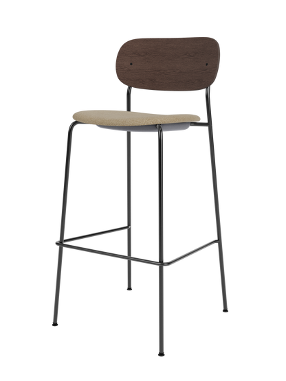 Co Bar Chair featuring a beige bouclé upholstered seat, dark stained oak backrest and a slender black steel frame.