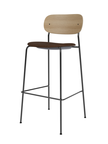 Co Bar Chair featuring a natural oak backrest and black bouclé upholstered seat on a slender black steel frame.