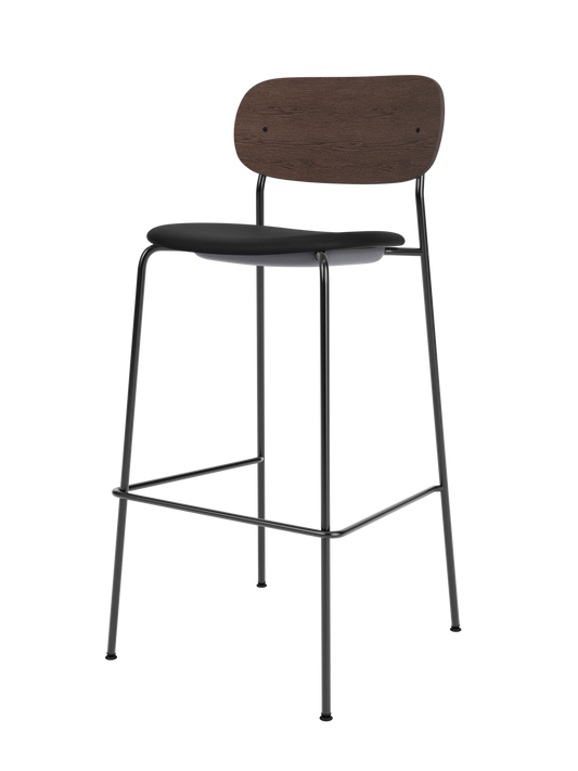 Co Bar Chair with a dark stained oak back, black upholstered seat and slender steel frame with a footrest.