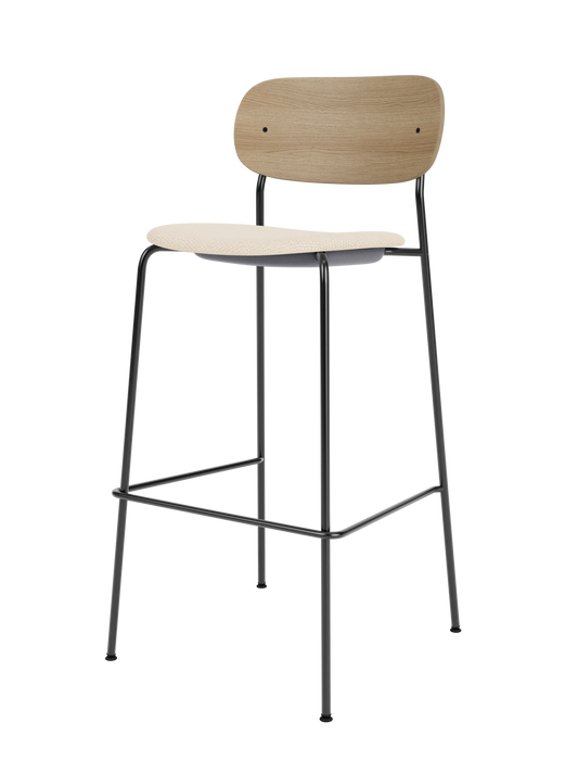 Co Bar Chair with natural oak backrest and Logan Jasmine upholstered seat, set on a slender black steel frame.