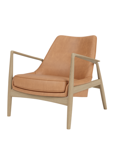 The Seal Lounge Chair, Low Back, featuring tan Dunes Camel leather and an angled natural oak frame with a floating seat.
