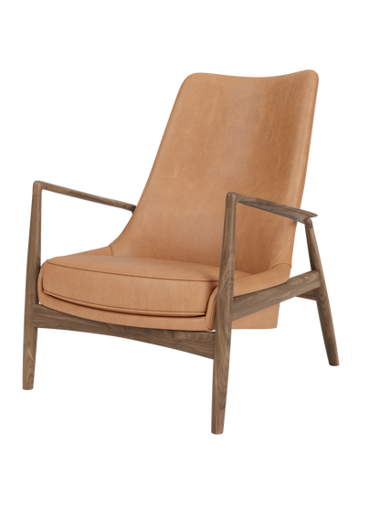 The Seal Lounge Chair, High Back in camel leather and solid walnut frame, featuring signature angled armrests.
