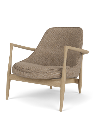Studio photograph of the Elizabeth Lounge Chair. The chair has a natural oak frame and is upholstered in Logan Flint fabric.