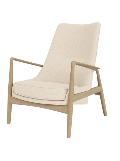 The Seal Lounge Chair, High Back, featuring a natural oak frame and Logan Jasmine cream textured upholstery.