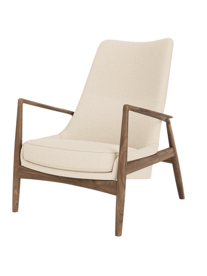 The Seal Lounge Chair, High Back featuring a solid walnut frame and cream Logan Jasmine textured upholstery.
