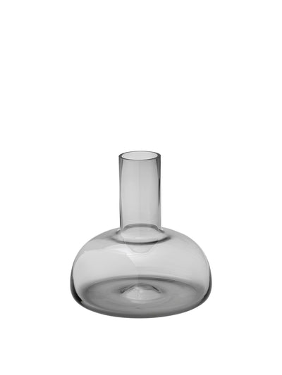 Front view of the Still Carafe in smoked glass, featuring a wide, rounded base and a short, cylindrical neck.