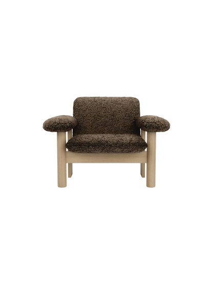 Front view of the Brasilia Lounge Chair, Low Back. The chair has a natural oak frame and dark brown Sheepskin Root upholstery