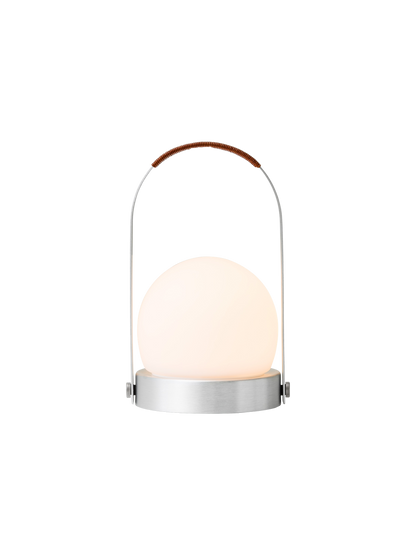 Illuminated Carrie Table Lamp featuring a brushed aluminium base, glowing opal shade and a leather-wrapped handle.