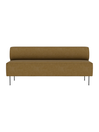 Front view of the Eave Dining Sofa in a mustard-coloured fabric, featuring a long seat, low back, and slender metal legs.