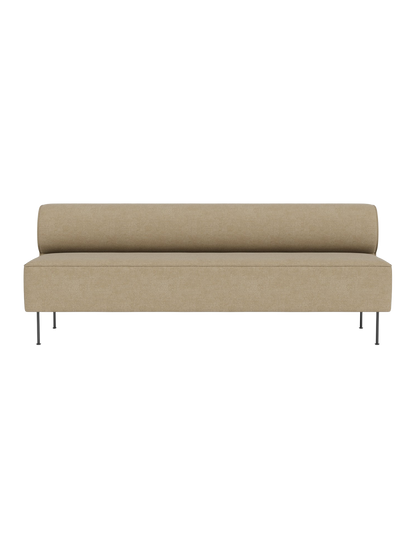 Front view of the Eave Dining Sofa in Audo Bouclé 02. The minimalist sofa has a low, rounded back and slim metal legs.