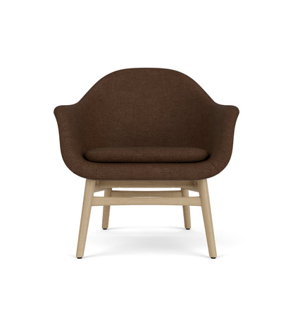 Sculptural Harbour Lounge Chair with dark brown boucl  upholstery and a solid natural oak wood frame.