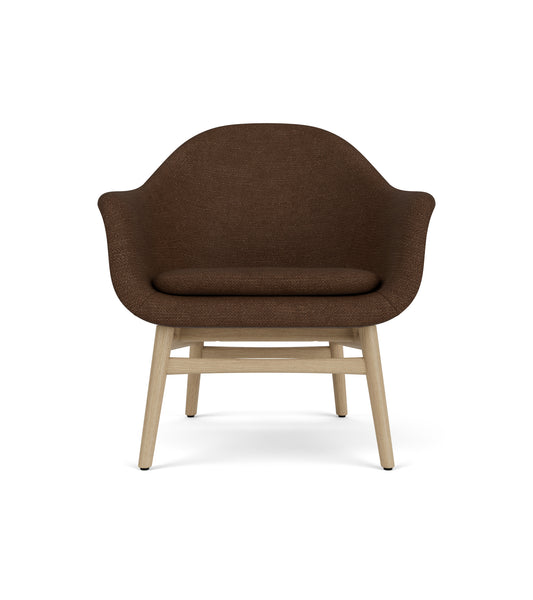 Sculptural Harbour Lounge Chair with dark brown boucl  upholstery and a solid natural oak wood frame.
