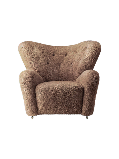Front view of The Tired Man Lounge Chair in Sahara sheepskin, with a high back, button tufting and plush arms.