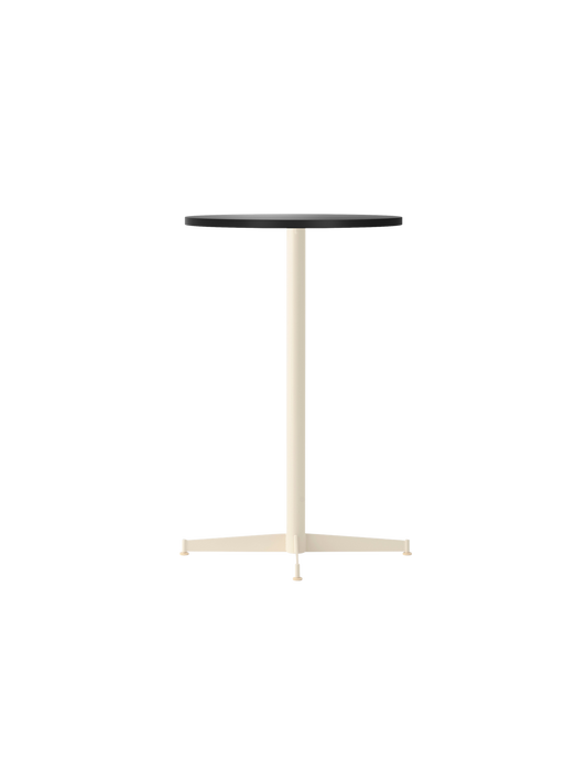 The Nook Counter Table with a round charcoal linoleum top and an ivory powder-coated steel base, shown from an angle.