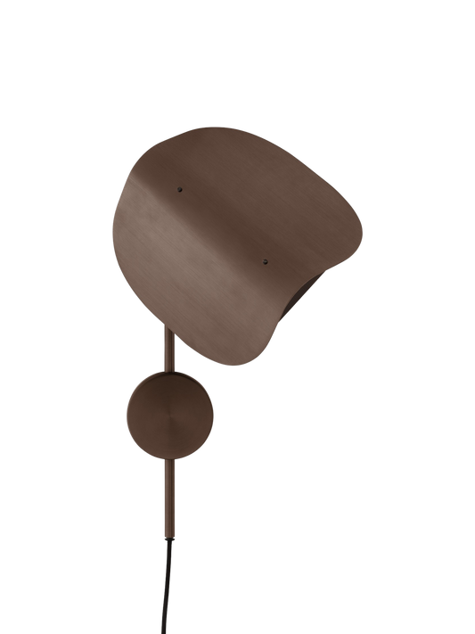 The Wing Wall Lamp in bronzed aluminium, turned off against a black background. It has a distinctive wing-shaped shade.