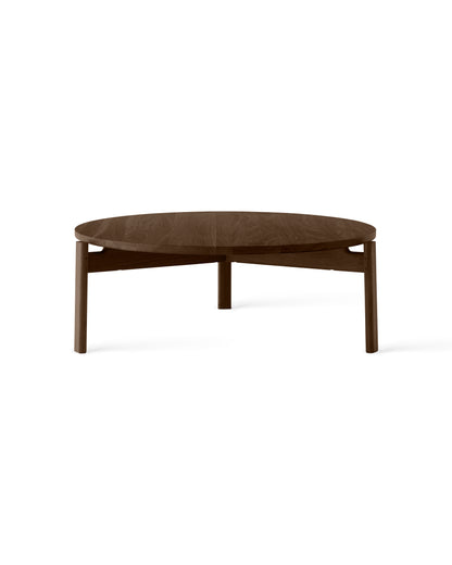 Round dark walnut wooden coffee table with tapered legs and visible wood grain, shown on white background