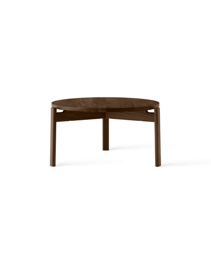 Round walnut wooden side table with tapered legs and visible grain, shown front-on against white background