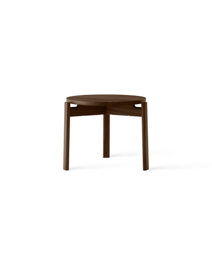 Round walnut side table with three slightly tapered legs and smooth finish, view of top and upper frame.