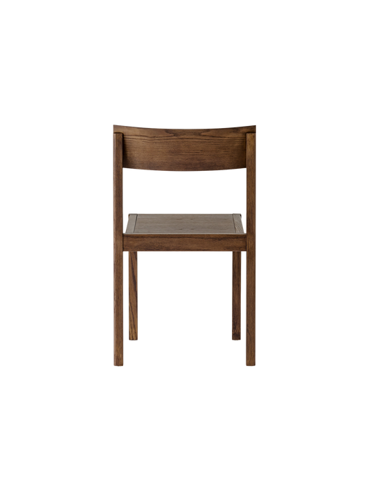 Dark-stained oak Mauro Dining Chair seen from behind, showing the curved veneer backrest and solid wood frame.
