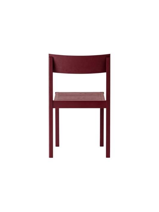 French red Mauro Dining Chair seen from behind, showing the curved oak veneer backrest and solid wood frame.