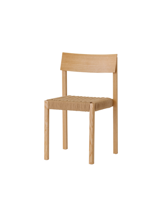 Mauro Dining Chair in natural oak with a handwoven papercord seat, showcasing its minimalist wood frame from an angle.