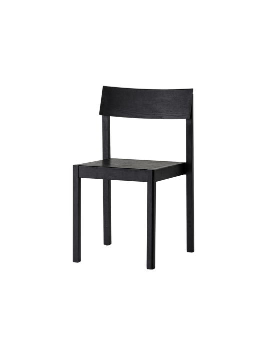 Mauro Dining Chair in black oak with a minimalist wooden frame and curved backrest, shown from a three-quarter angle.