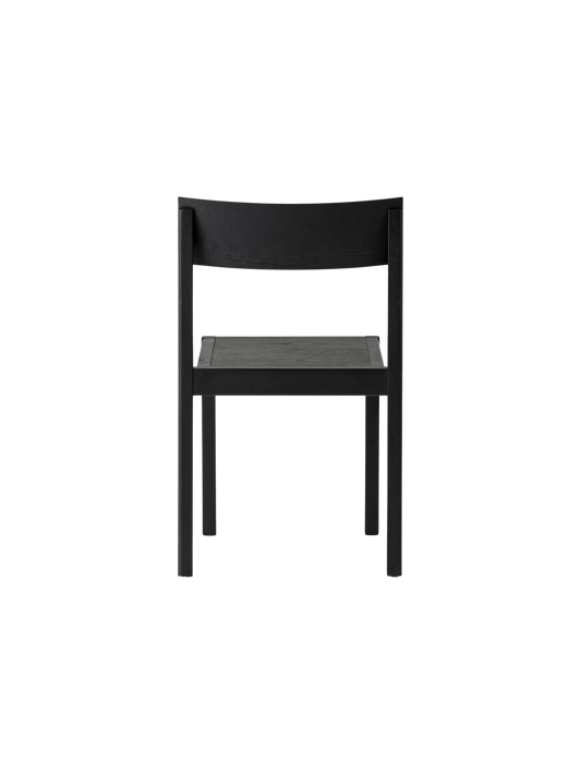 Black Mauro Dining Chair seen from behind, highlighting its solid oak frame and curved wooden backrest.