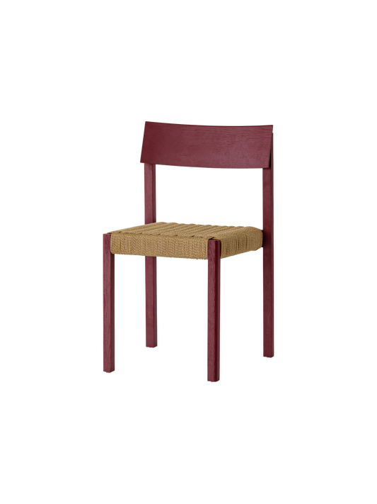 French red Mauro Dining Chair featuring a handwoven paper cord seat and solid wood frame, shown from an angled profile.