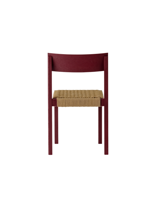 Mauro Dining Chair in French Red Oak with a handwoven papercord seat, shown from a rear perspective.
