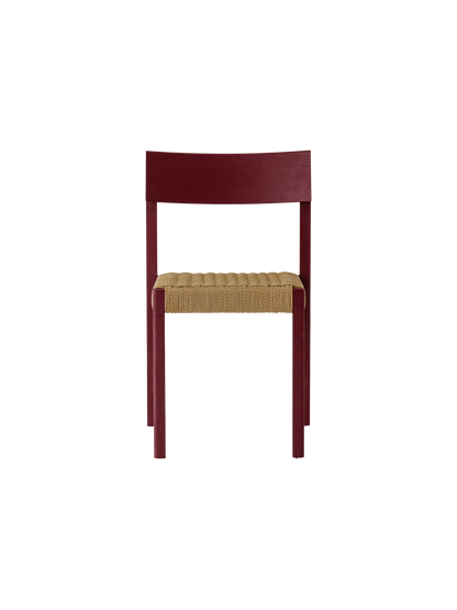 Mauro Dining Chair in French red oak with a handwoven paper cord seat, shown in a straight-on front view.