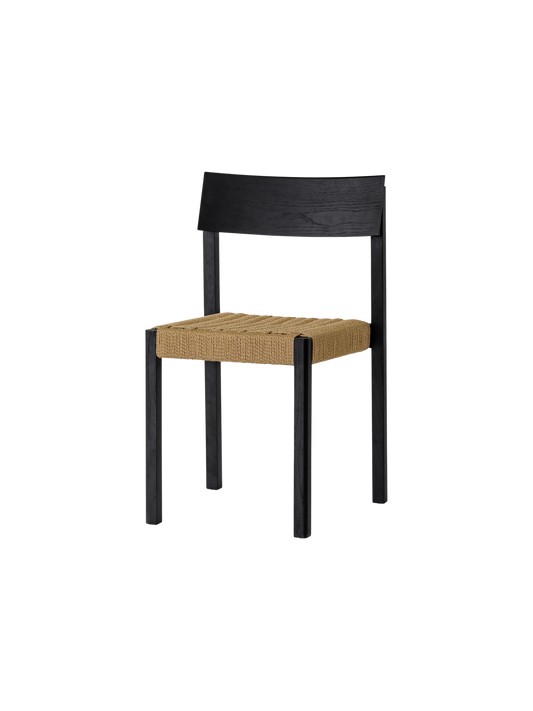 Mauro Dining Chair in black oak with a handwoven natural paper cord seat, shown from a three-quarter angle.