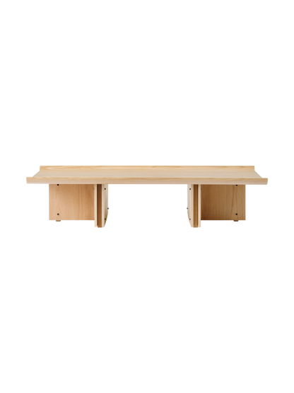 Conrad Lounge Table in natural oak veneer, shown from the front against a black background.