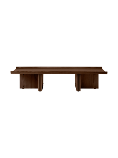 Low walnut wood bench with rectangular top, raised edges and two solid panel legs, minimalist Danish design