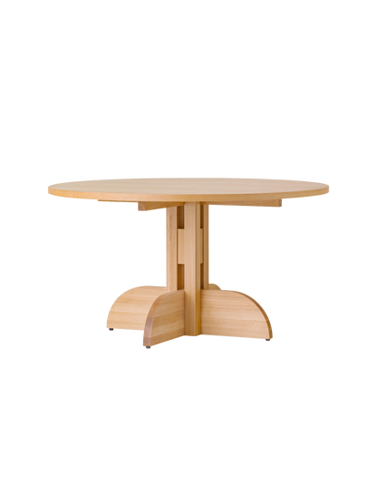 Round Puffin Dining Table in natural oak with a sculptural solid wood base, isolated on a plain white background.