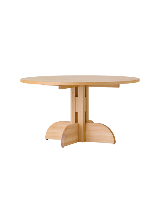 Round Puffin Dining Table in natural oak with a sculptural solid wood base, isolated on a plain white background.